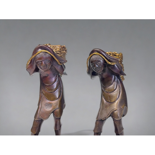 35 - A PAIR OF JAPANESE BRONZE OKIMONO. Meiji period. Depicting men stood on the backs of toads, carrying... 