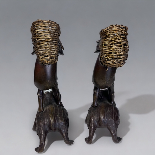 35 - A PAIR OF JAPANESE BRONZE OKIMONO. Meiji period. Depicting men stood on the backs of toads, carrying... 