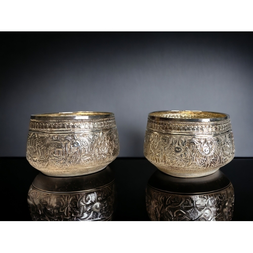 38 - A PAIR OF BURMESE SILVER THABEIK BOWL. Repousse decorated with fish and crabs amongst stylised folia... 