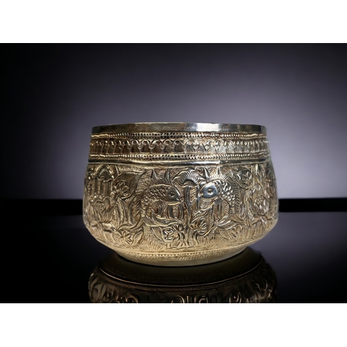 38 - A PAIR OF BURMESE SILVER THABEIK BOWL. Repousse decorated with fish and crabs amongst stylised folia... 