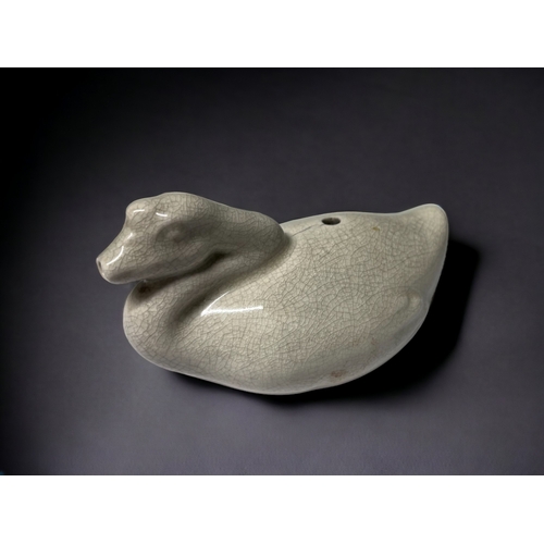 51 - A CHINESE PORCELAIN ZOOMORPHIC WATER DROPPER. Crackle ground, Modelled as a Goose on the water. 5 x ... 