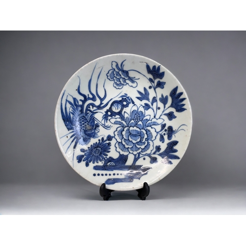 53 - A CHINESE PORCELAIN BLUE & WHITE DISH. Qing dynasty. Painted with a Phoenix and large blossoming... 