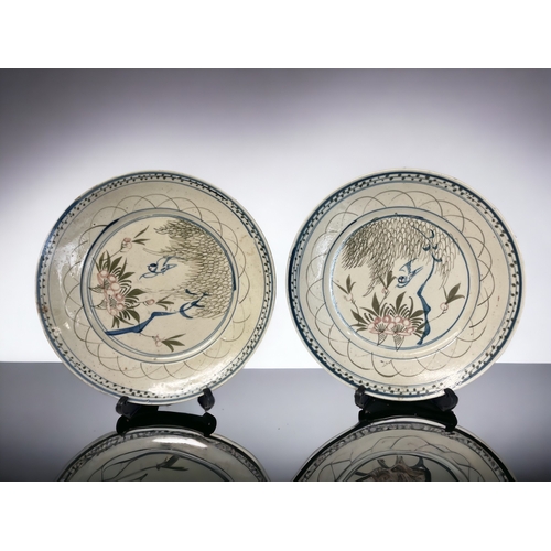 88 - A pair of 19th century Chinese plates. 
Hand painted with flying birds blossoming flowers below a Wi... 