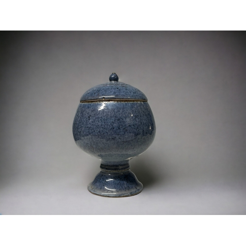 102 - A Chinese Jun type glaze lidded jar. Moon jar form on raised foot, with mottled blue glaze. Height -... 