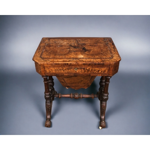 128 - A VICTORIAN BURR WALNUT WORK TABLE. Carved legs raised on original casters. Joined by turned wood st... 