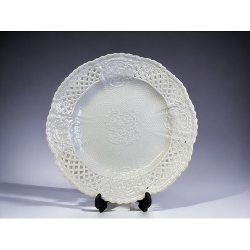 463 - A 19th century Meissen porcelain plate.
White glazed, with moulded 'Rose' blossoms, with weave desig... 