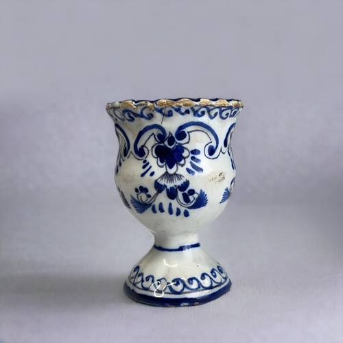 466 - A BLUE & WHITE PAINTED DUTCH DELFT EGG CUP. 18th-Century. moulded form, with painted stylised fo... 