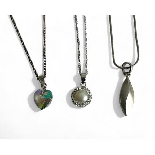 404 - Three ladies silver pendant necklaces.