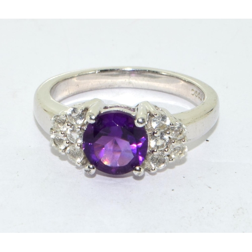 435 - 925 silver ladies Amethyst set with stone decoration to the side ring size O