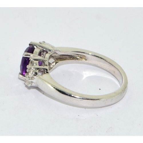 435 - 925 silver ladies Amethyst set with stone decoration to the side ring size O