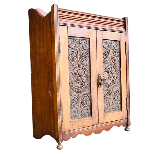 10 - Oak Wall Smokers Cabinet with heavily carved door panels.Height 42 x  width 33cm x depth 18cm