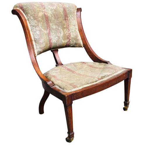 28 - Late 19thC spoonback upholstered low chair.  Mahogany framed with brass casters.