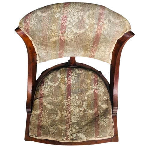 28 - Late 19thC spoonback upholstered low chair.  Mahogany framed with brass casters.