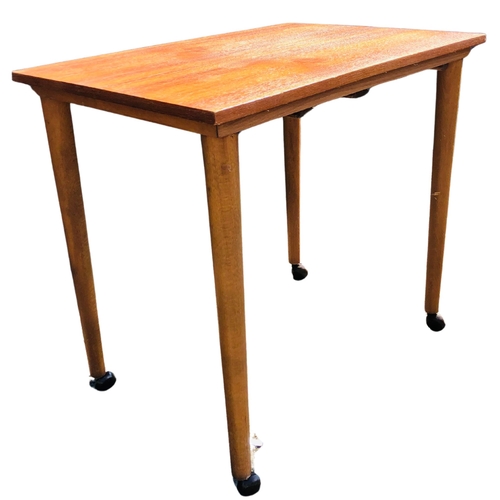 7 - Small  Mid Century Table on original casters. Made in Czechoslovakia. Beech construction with a teak... 