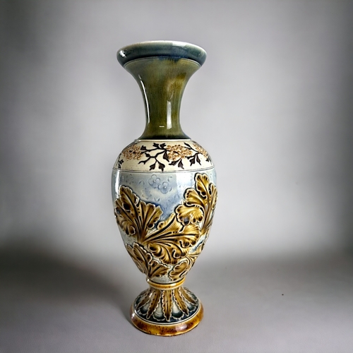 506 - An Art Nouveau Doulton Lambeth vase.Carved relief foliate design. Height - 26cm