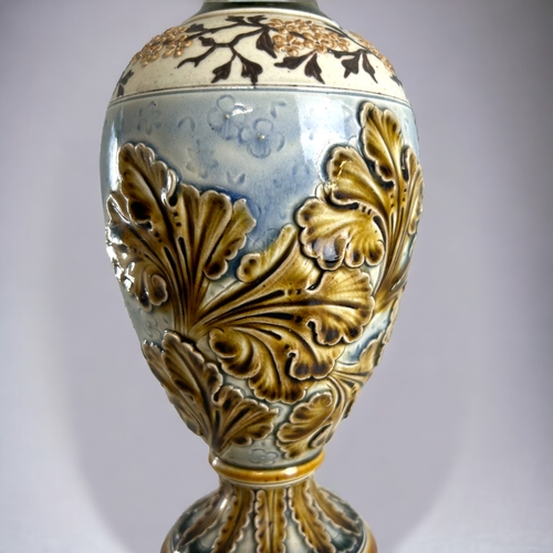 506 - An Art Nouveau Doulton Lambeth vase.Carved relief foliate design. Height - 26cm