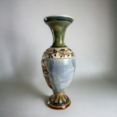 506 - An Art Nouveau Doulton Lambeth vase.Carved relief foliate design. Height - 26cm