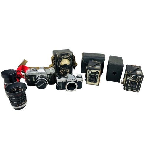 39 - Assortment of Vintage Cameras and lenses to include Cannon and Olympus Etc.