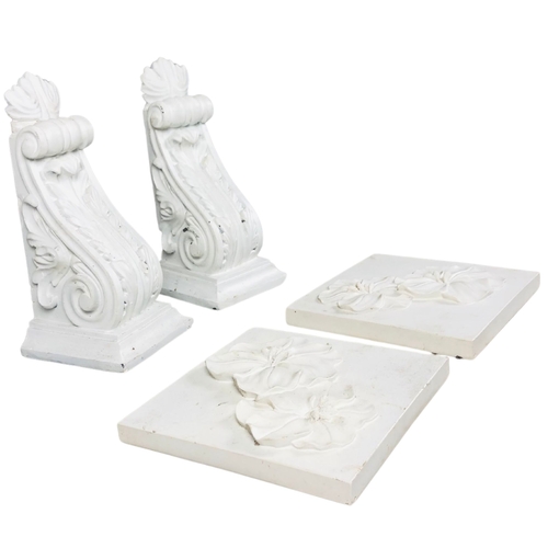 138 - Pair of plaster corbels and 2 resin wall hangings.