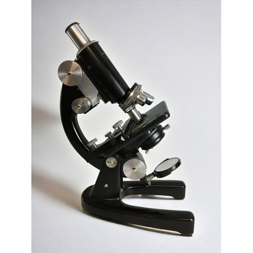 381 - A mid-20th century black enamelled monocular microscope, signed 'J. Swift & Son London' and numb... 