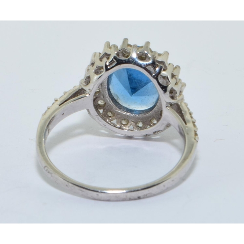 212 - 925 silver large marine colour blue centre stone in a halo design size U