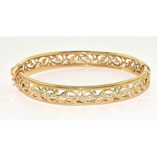 231 - 9ct gold open work bangle with spring closed mechanism, 9.3g