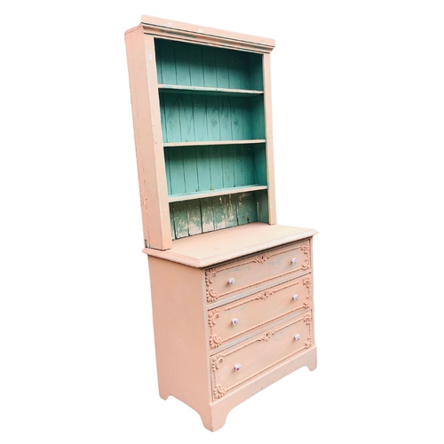 1 - 3 shelf pink painted bookcase over a 3 drawer chest of drawers approx 184cm x 84cm wide x 45cm