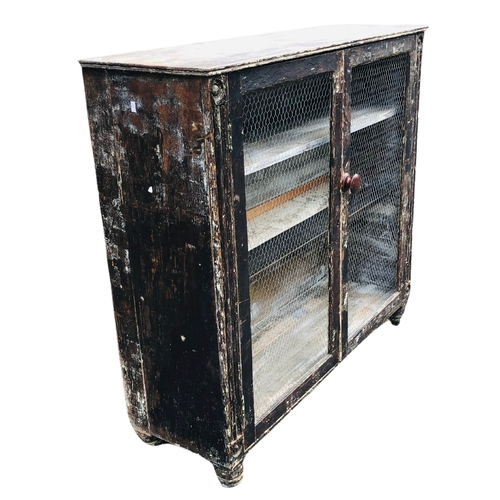 2 - Distressed shabby chic painted bookcase with wire to the doors. Approx Width 110cm x depth 37cm x he... 