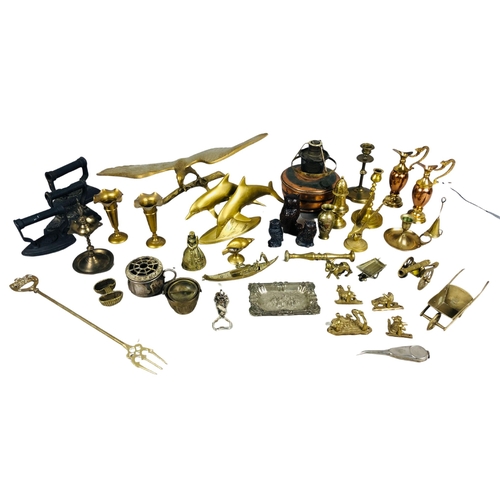 64 - Assortment of brass and copper items to include a toasting fork, candlesticks etc and two antique fl... 