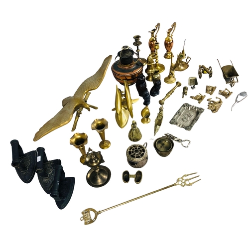 64 - Assortment of brass and copper items to include a toasting fork, candlesticks etc and two antique fl... 