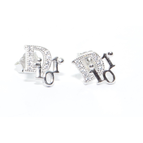 242 - A pair of silver Dior style earrings 