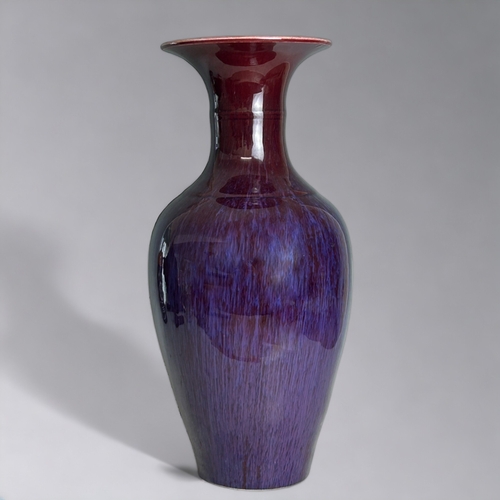 91 - A Chinese Flambe' glazed vase.20th Century, Baluster form.Ox-blood running to purple & lavender.... 