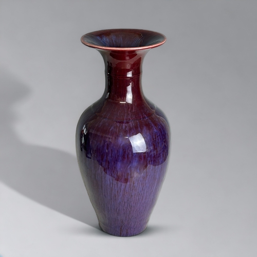 91 - A Chinese Flambe' glazed vase.20th Century, Baluster form.Ox-blood running to purple & lavender.... 