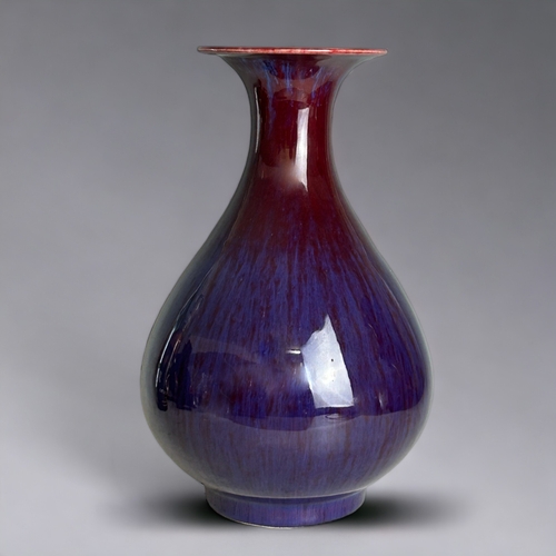 63 - A Chinese Flambe' glazed pear shape vase.20th Century, Ox-blood running to purple & lavender.Mar... 