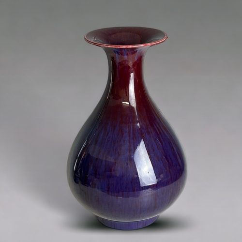 63 - A Chinese Flambe' glazed pear shape vase.20th Century, Ox-blood running to purple & lavender.Mar... 