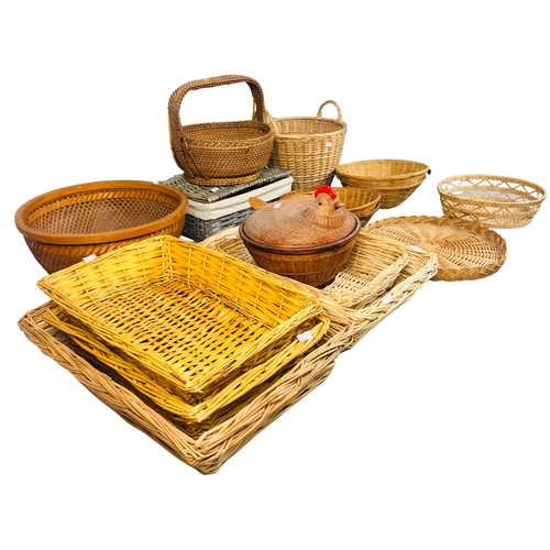 108 - Collection of Wicker Baskets and Trays to include a covered basket in the form of a sitting hen.