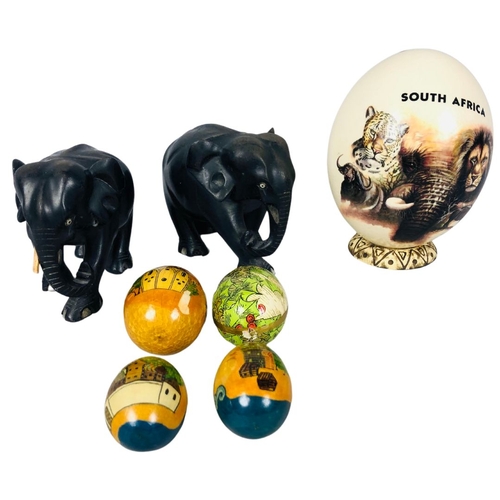 132 - Painted and signed ostrich egg together with 2 vintage carved wooden elephants and a collection of 4... 