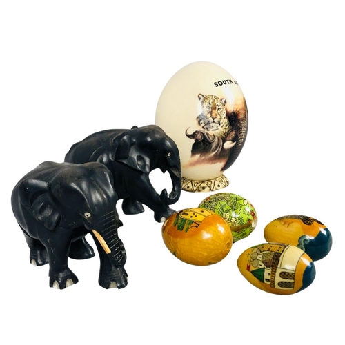 132 - Painted and signed ostrich egg together with 2 vintage carved wooden elephants and a collection of 4... 