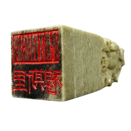 195 - Carved Chinese soapstone seal, together with a bronze buddha and Inuit style carving.