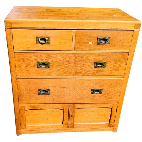 14 - Honeyed oak 2 over 2 chest of drawers with campaign style handles and cupboard door at the bottom.  ... 