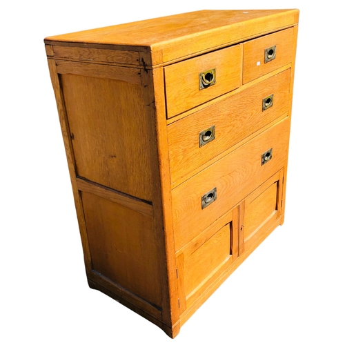 14 - Honeyed oak 2 over 2 chest of drawers with campaign style handles and cupboard door at the bottom.  ... 