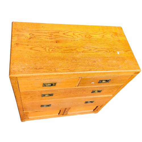 14 - Honeyed oak 2 over 2 chest of drawers with campaign style handles and cupboard door at the bottom.  ... 