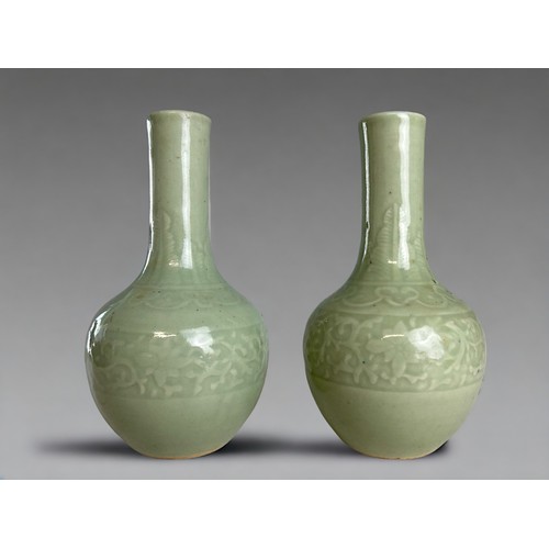 67 - A pair of Chinese Celadon Longquan type porcelain vases.Qing dynasty.Carved foliate design band to b... 