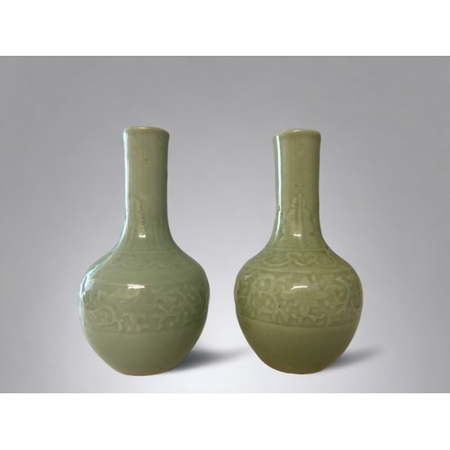 67 - A pair of Chinese Celadon Longquan type porcelain vases.Qing dynasty.Carved foliate design band to b... 