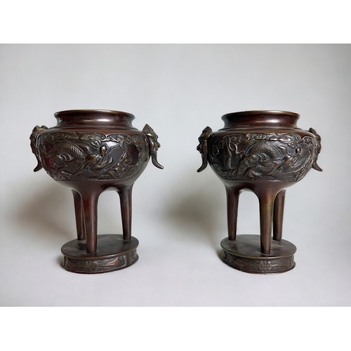 59 - A pair of Japanese bronze Koro / vases.Meiji period.Tripod form on raised base. Onde side decorated ... 