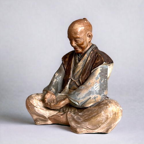 60 - A Japanese Hakata doll.Depicting a smiling old man (Nikoniko). Unglazed & and painted.Height - 2... 