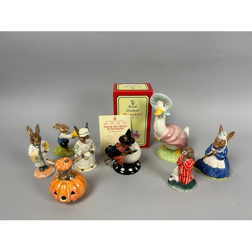 143 - A collection of eight Royal Doulton Bunnykins figurines. Including a boxed 'Trick or Treat' figurine... 