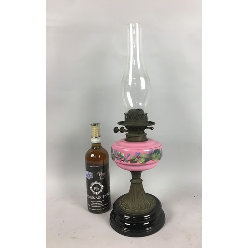 449 - Victorian Oil Lamp, Pink Opaline Glass Reservoir with Foliate Decoration Upon a Black Ceramic Base. ... 