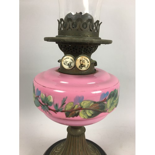 449 - Victorian Oil Lamp, Pink Opaline Glass Reservoir with Foliate Decoration Upon a Black Ceramic Base. ... 