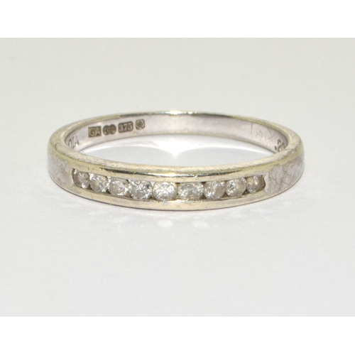 287 - A 9ct white gold Diamond 1/2 eternity ring with Chanel set diamonds Hall marked as 0.2ct Diamond in ... 